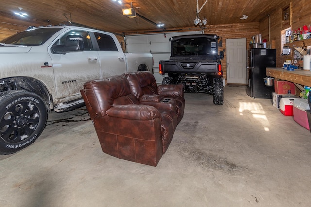 garage with black refrigerator, a garage door opener, and wooden ceiling