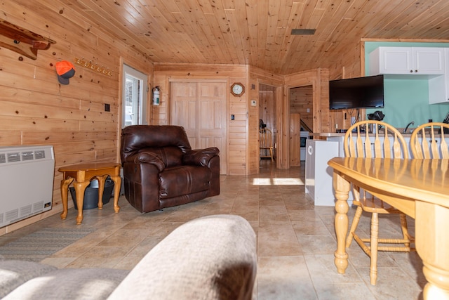 tiled living room featuring wood ceiling, radiator heating unit, wooden walls, and heating unit