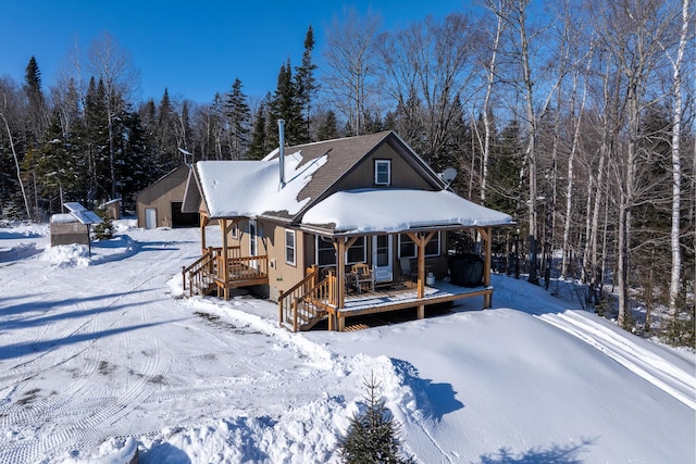 view of snow covered rear of property