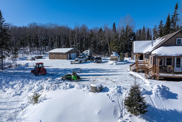 snowy yard with an outbuilding