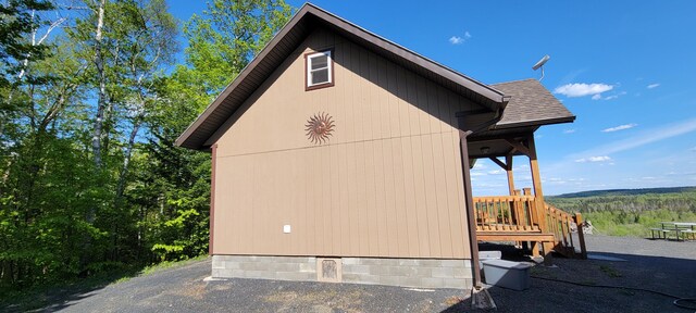 685 Main St, Grand Isle, ME 04746 - view of side of home featuring a wooded view