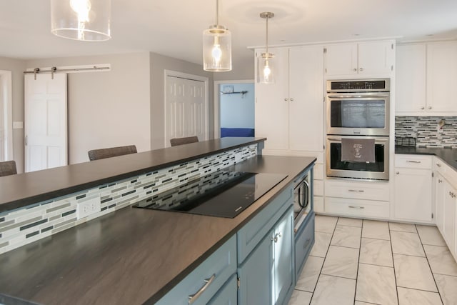 kitchen with white cabinetry, stainless steel appliances, blue cabinetry, and pendant lighting