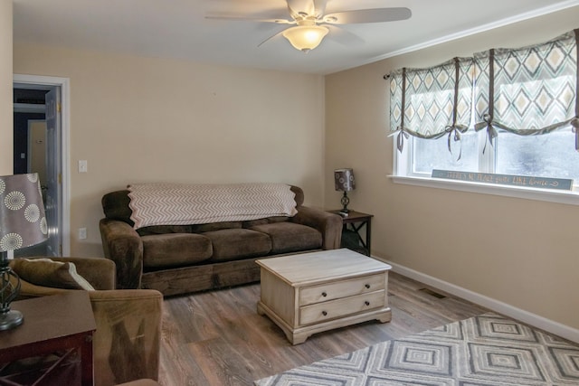 living room featuring wood-type flooring and ceiling fan