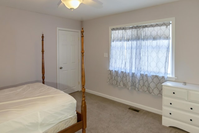 bedroom featuring light carpet and ceiling fan