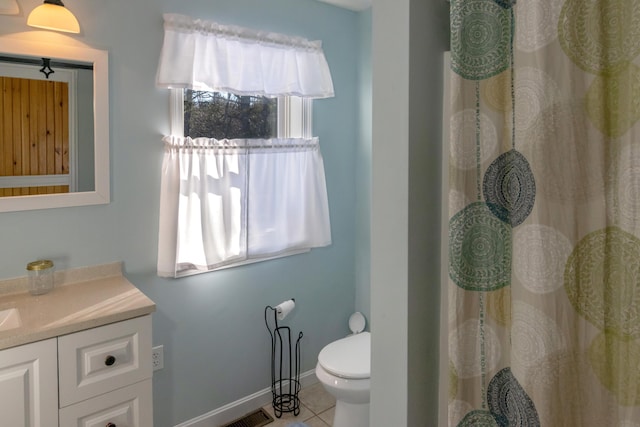 bathroom featuring vanity, tile patterned floors, and toilet