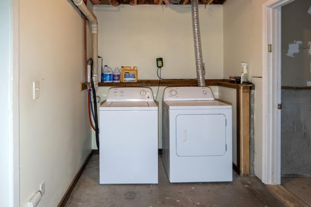 clothes washing area with washer and clothes dryer