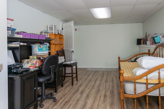 office featuring hardwood / wood-style flooring and a drop ceiling