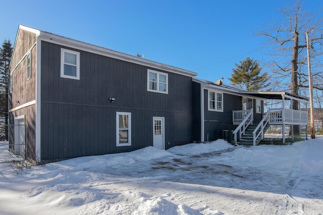 view of snow covered rear of property