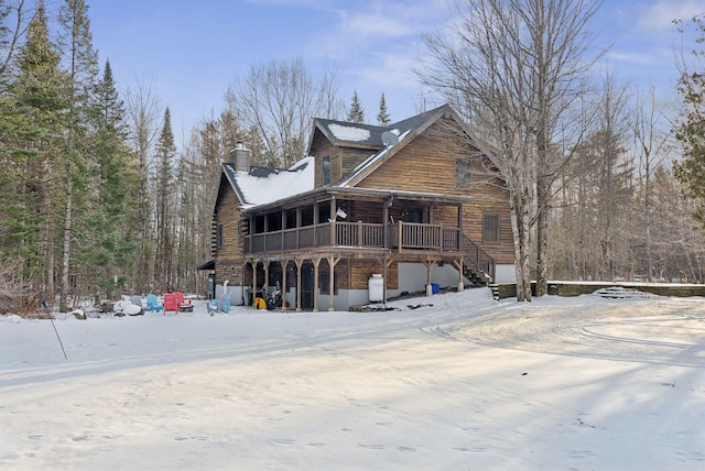 view of snow covered rear of property