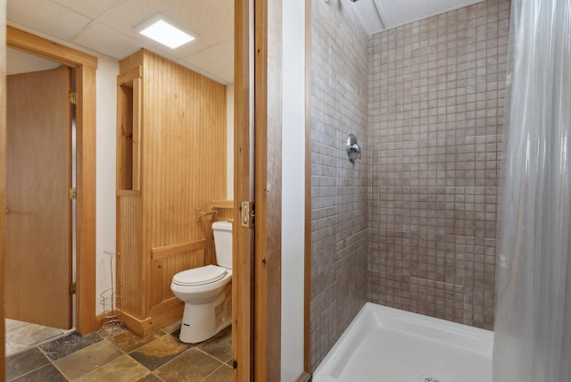 bathroom featuring walk in shower and toilet