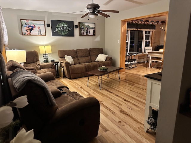 living room with ceiling fan and light hardwood / wood-style floors