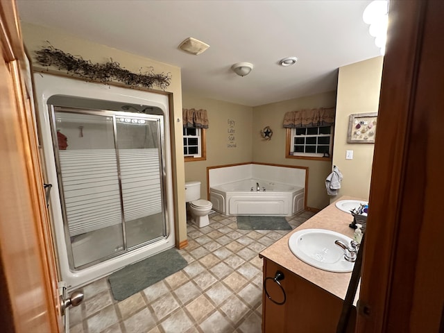 full bathroom featuring vanity, toilet, and independent shower and bath