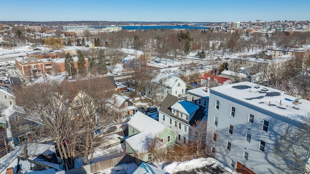 snowy aerial view featuring a water view