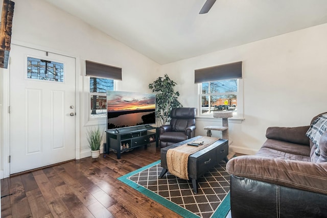 living room featuring dark wood-type flooring, vaulted ceiling, and ceiling fan