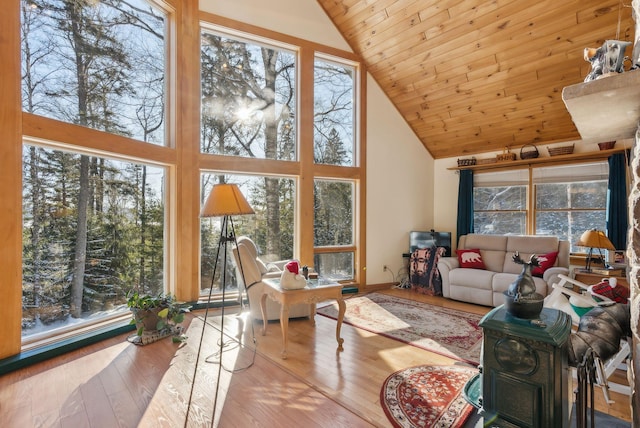 living room with wooden ceiling, high vaulted ceiling, and light wood-type flooring