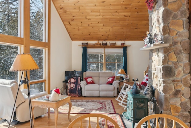 living room with wood ceiling, high vaulted ceiling, and light hardwood / wood-style flooring