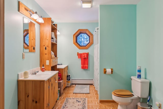 bathroom with parquet flooring, a baseboard radiator, vanity, and toilet