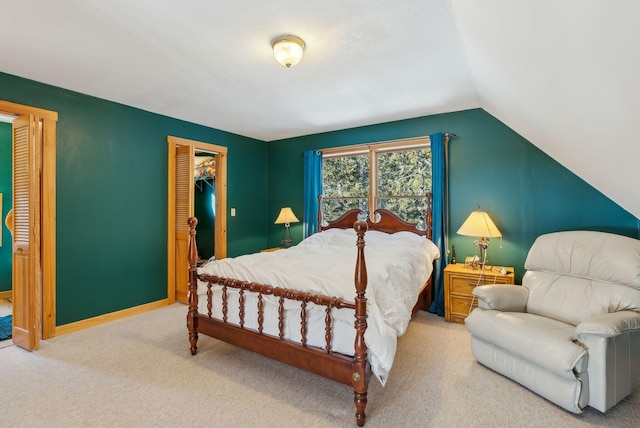 carpeted bedroom with vaulted ceiling and a closet