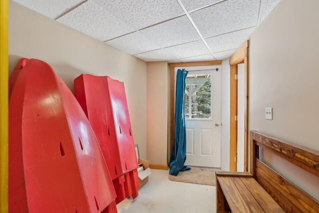 interior space with a drop ceiling and concrete flooring