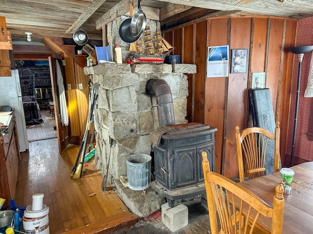 interior space with wood-type flooring and a wood stove