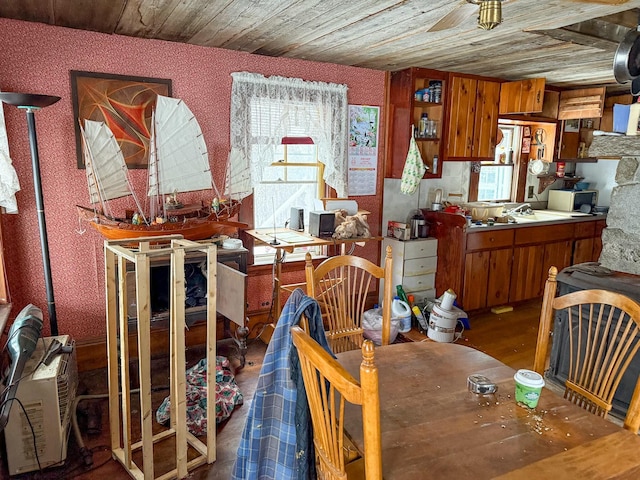 dining area featuring dark wood-type flooring, wooden ceiling, and ceiling fan