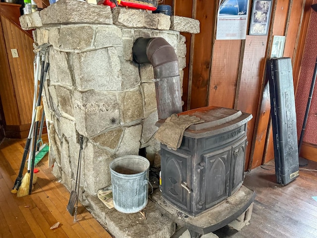 interior details featuring hardwood / wood-style floors and a wood stove