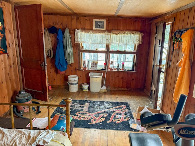 misc room featuring wooden walls and light hardwood / wood-style floors