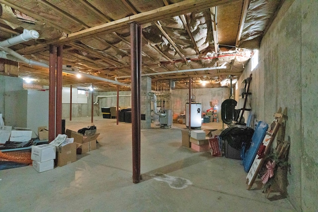 unfinished basement featuring water heater