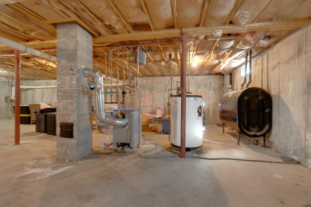 unfinished below grade area featuring water heater and heating fuel