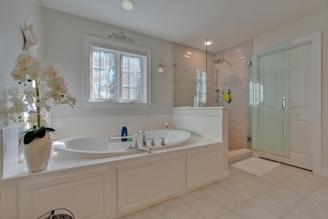 full bath featuring a bath and a shower stall