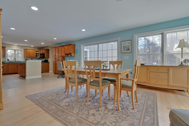 dining room with recessed lighting and light wood-type flooring