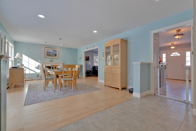 dining room with a baseboard heating unit, recessed lighting, and baseboards