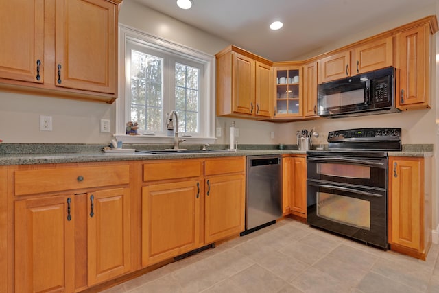 kitchen with a sink, visible vents, black appliances, light tile patterned flooring, and recessed lighting