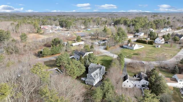 birds eye view of property featuring a residential view and a wooded view