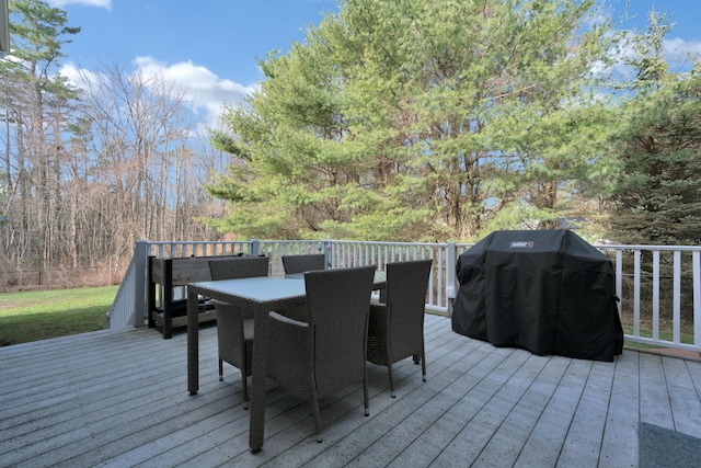 deck featuring outdoor dining space and area for grilling