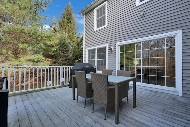 deck featuring area for grilling and outdoor dining area