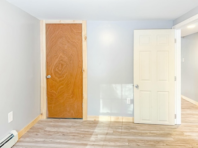 21 Coolidge Rd, Dixfield, ME 04224 - unfurnished room featuring baseboards, a baseboard radiator, and wood finished floors