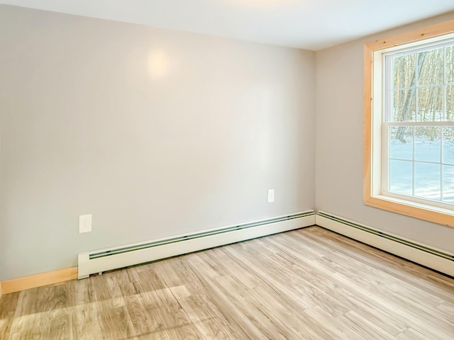 21 Coolidge Rd, Dixfield, ME 04224 - empty room with wood finished floors and a baseboard radiator