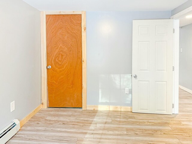 21 Coolidge Rd, Dixfield, ME 04224 - spare room featuring baseboards, a baseboard heating unit, and wood finished floors