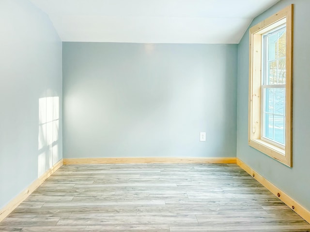21 Coolidge Rd, Dixfield, ME 04224 - spare room with a healthy amount of sunlight, light wood finished floors, and lofted ceiling