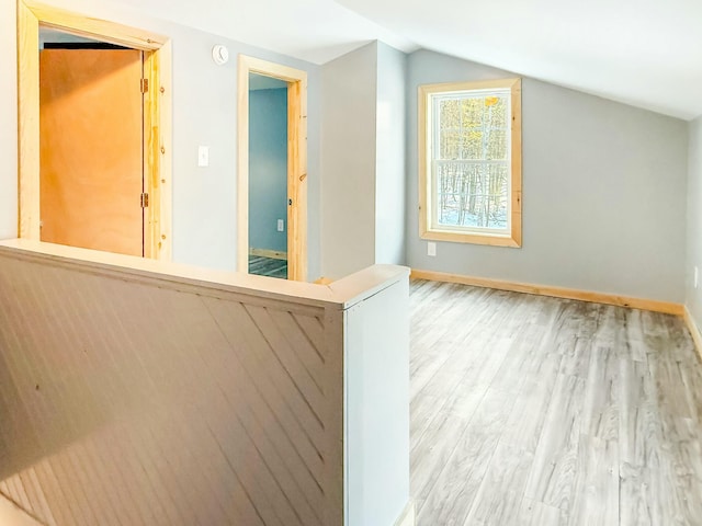 21 Coolidge Rd, Dixfield, ME 04224 - additional living space with baseboards, wood finished floors, and vaulted ceiling