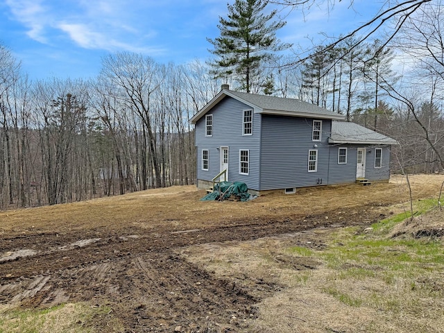 21 Coolidge Rd, Dixfield, ME 04224 - view of side of home featuring roof with shingles and a chimney