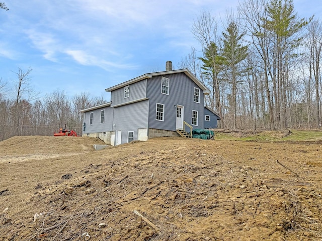 21 Coolidge Rd, Dixfield, ME 04224 - rear view of house featuring entry steps and a chimney