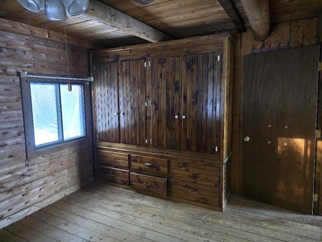 interior space featuring hardwood / wood-style flooring, beamed ceiling, wooden walls, and wood ceiling