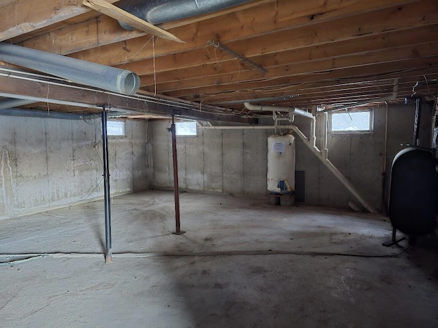 basement featuring water heater and heating fuel