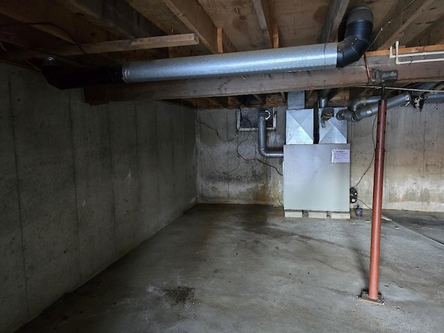 unfinished below grade area featuring heating unit