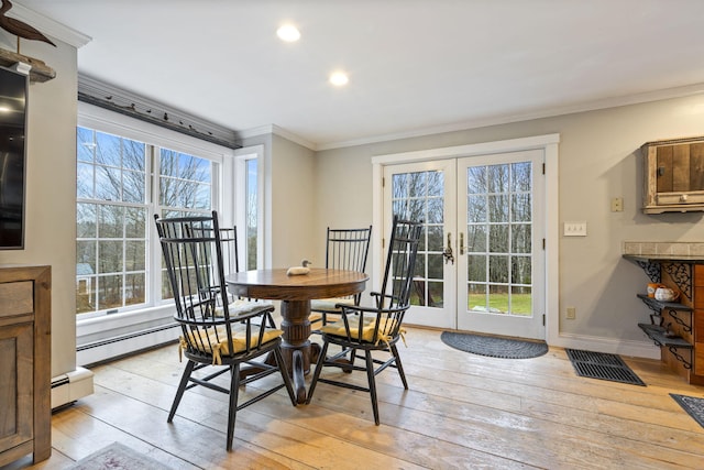 dining room with crown molding, plenty of natural light, light hardwood / wood-style floors, and french doors