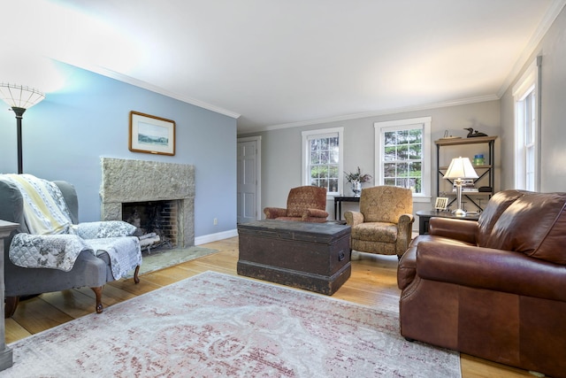 living room with ornamental molding and light hardwood / wood-style flooring