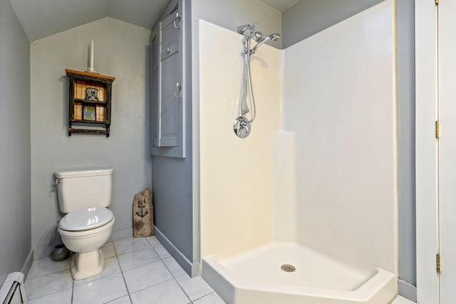 bathroom featuring walk in shower, lofted ceiling, toilet, tile patterned flooring, and a baseboard heating unit