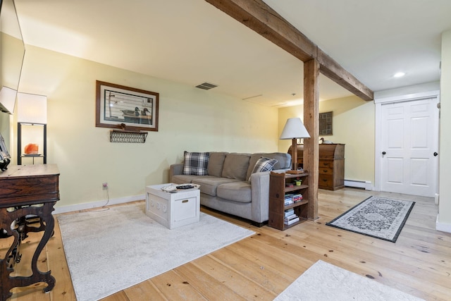 living room featuring beamed ceiling, a baseboard radiator, and light hardwood / wood-style flooring